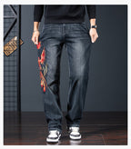 Phoenix Flight Embroidered Jeans featuring a vibrant phoenix design on the leg for a unique style