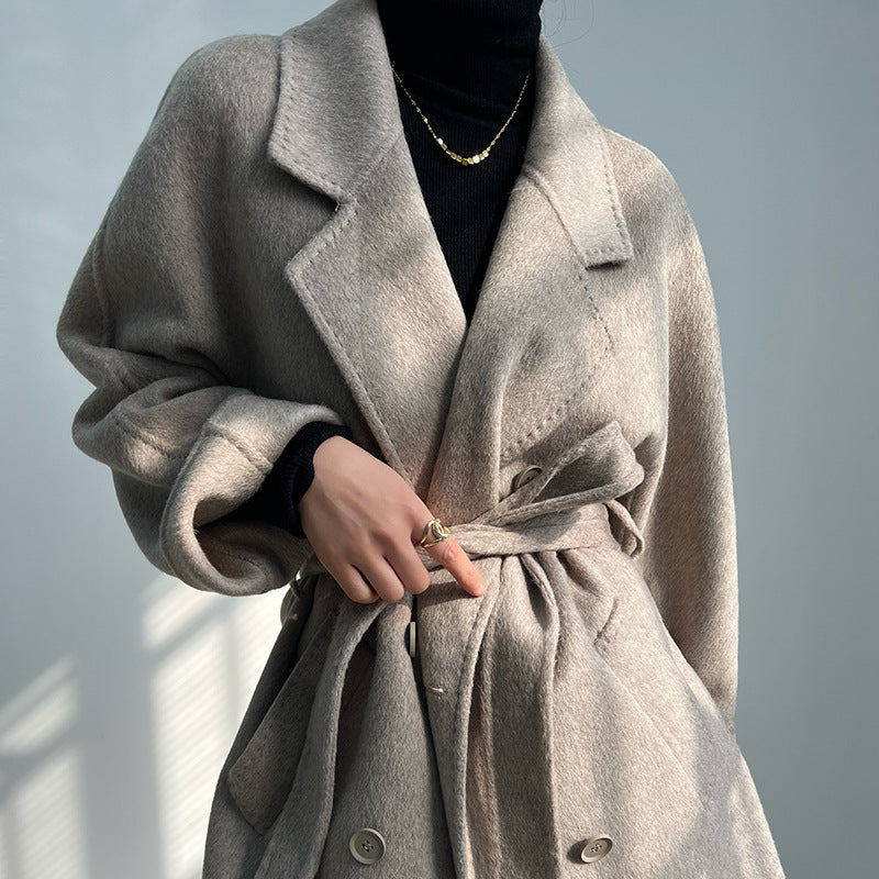 Adele Double Wool Coat in a beige color, featuring a belt and elegant oversized design