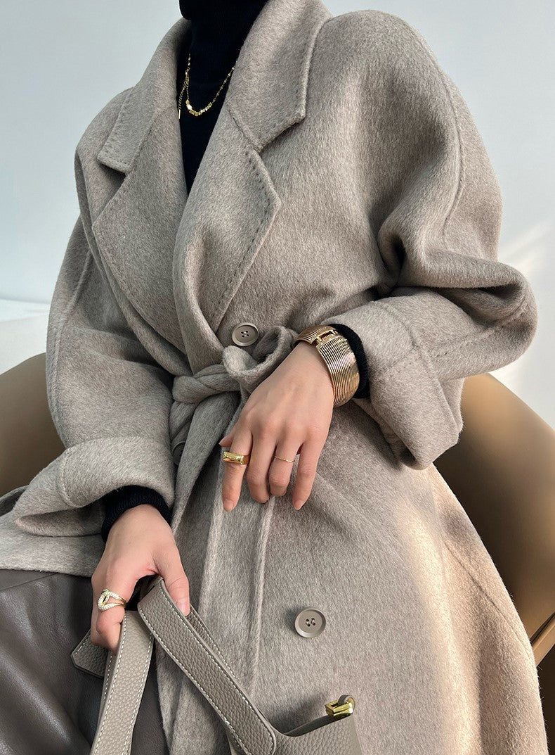 Adele Double Wool Coat in gray, featuring a belted waist and oversized sleeves for a stylish look