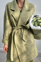 Adele Double Wool Coat in soft green with a belted waist and elegant design, perfect for stylish layering.
