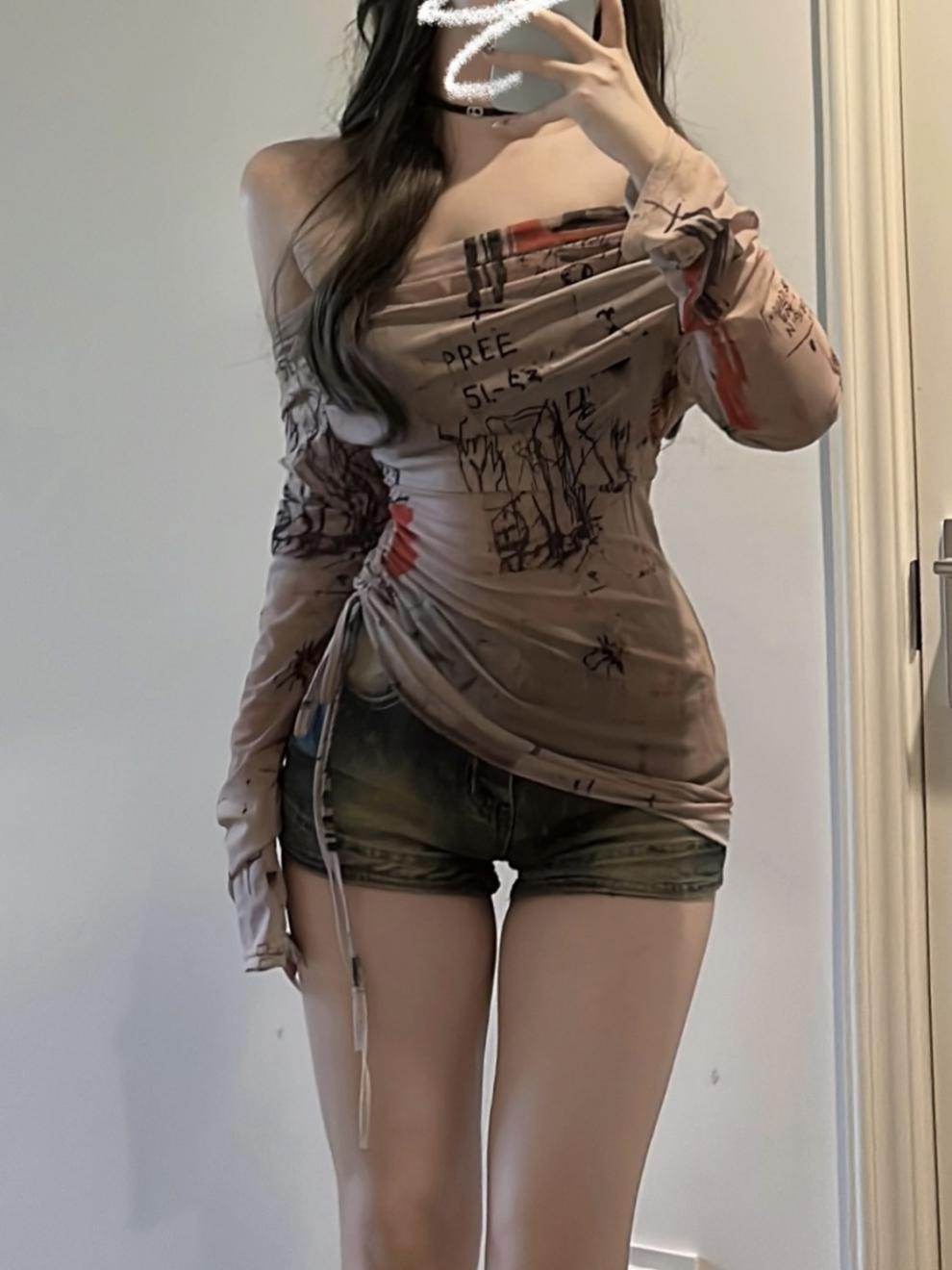 Stylish sheer asymmetric top with graphic print, perfect for casual outings and fashion-forward looks