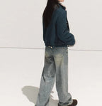 Model wearing Autumn Sparkling 3D Rhinestone Straight-Leg Jeans with a cozy blue jacket