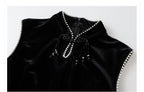 Elegant black velvet dress with beads featuring a high neckline and detailed embellishments