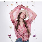 Blossom Whisper Ruffled Chiffon Blouse in pink with floral accents and a stylish hat for a trendy look