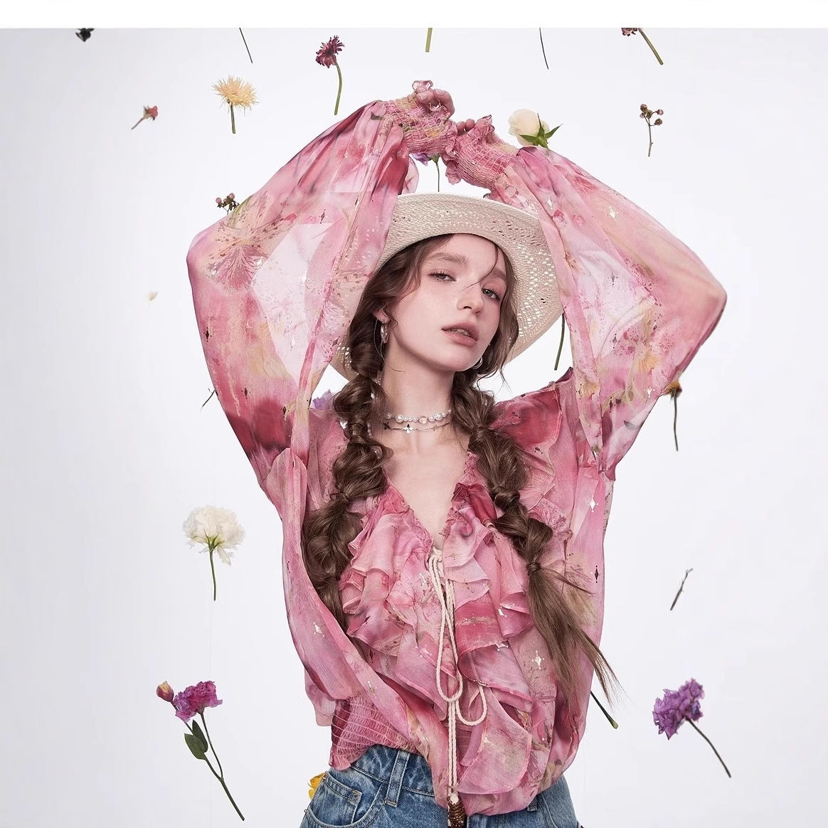 Blossom Whisper Ruffled Chiffon Blouse in pink with floral accents and a stylish hat for a trendy look