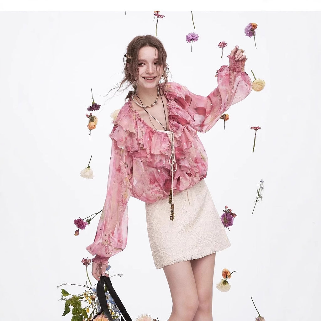 Model wearing a Blossom Whisper Ruffled Chiffon Blouse with floral accents in a trendy outdoor setting