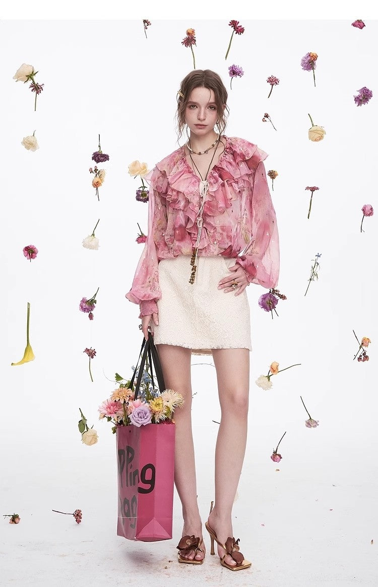 Blossom Whisper Ruffled Chiffon Blouse in pink, styled with a floral backdrop and paired with a skirt