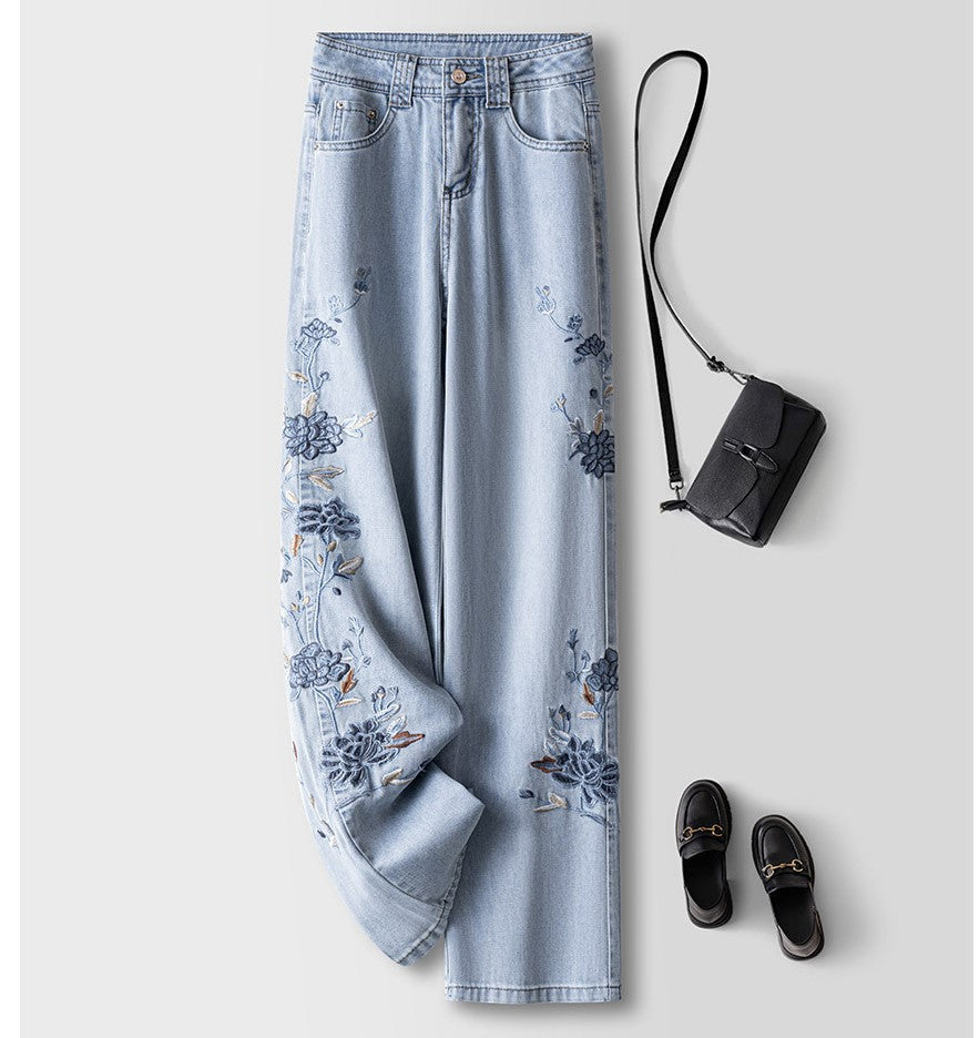 Blue Lotus Retro Embroidered Jeans with floral design, paired with a black handbag and slip-on shoes
