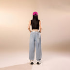 Model wearing Blue Rebel Ripped Street Jeans from AM Vision RO with a cropped top and cap