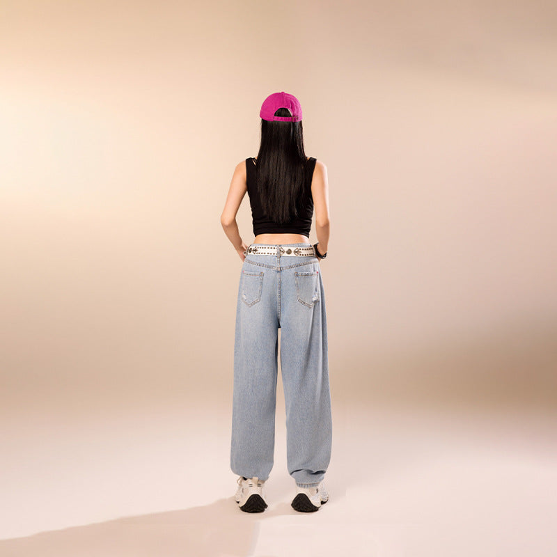 Model wearing Blue Rebel Ripped Street Jeans from AM Vision RO with a cropped top and cap