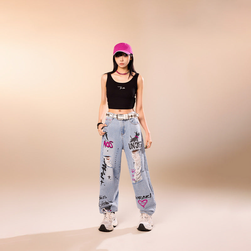 Model wearing Blue Rebel Ripped Street Jeans with graffiti designs and relaxed fit for a trendy look