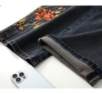 Close-up of Blue Sakura Embroidered Wide Leg Jeans showcasing detailed floral embroidery and hem design