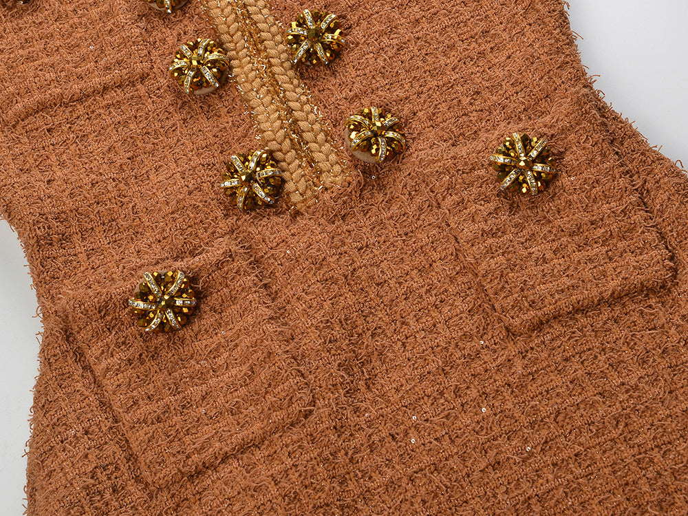 Close-up of Camille Knit Dress Wool Elegance featuring decorative buttons and textured fabric