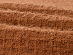 Close-up of Camille Knit Dress Wool Elegance fabric in rich brown texture with intricate knit pattern