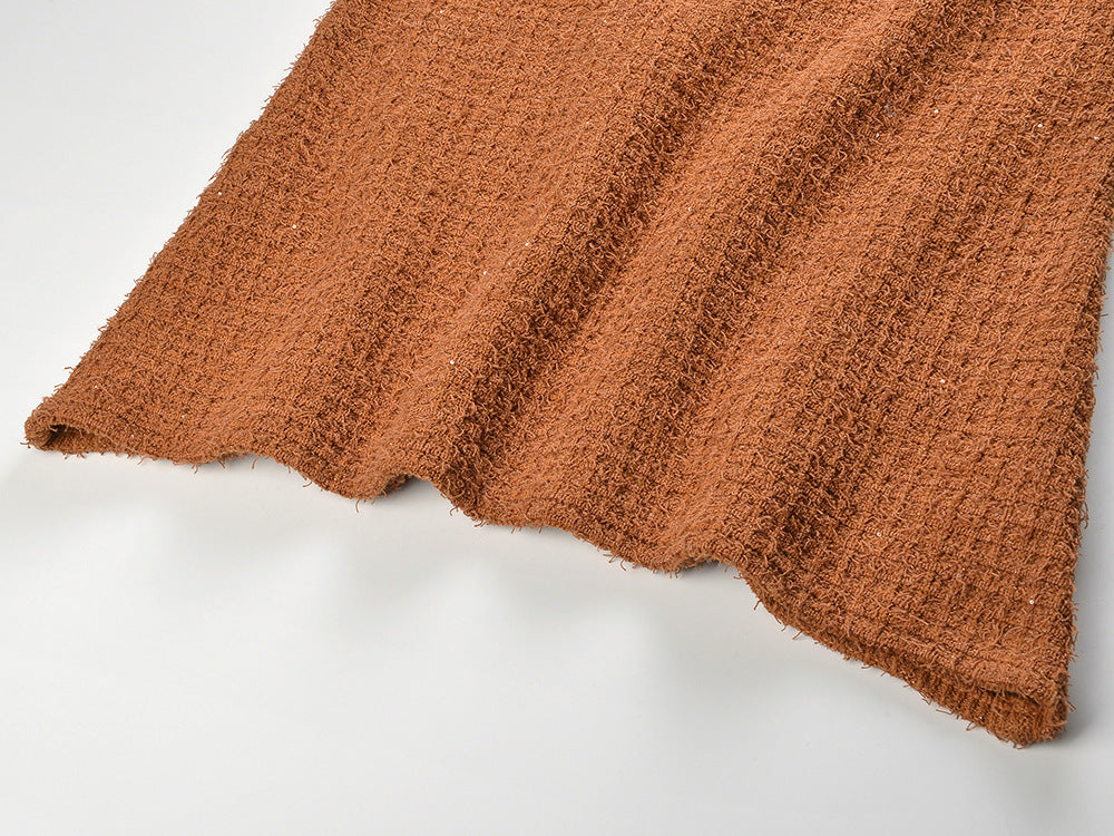 Close-up of warm, textured fabric showcasing the Camille Knit Dress Wool Elegance in a rich brown color