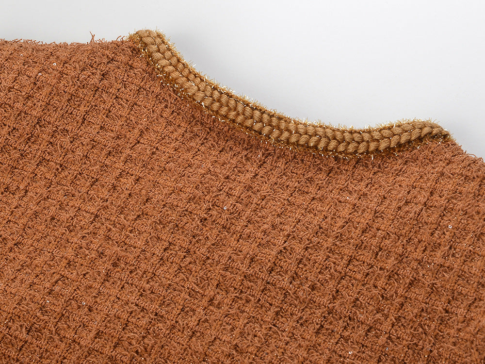 Close-up of the textured fabric of the Camille Knit Dress Wool Elegance in warm earthy tones