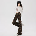 Stylish model wearing camouflage flare pants paired with a casual cropped top