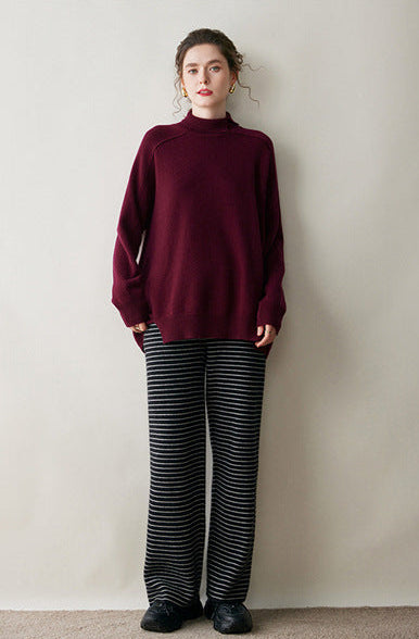 Burgundy AM Vision RO cashmere turtleneck sweater for women paired with striped wide-leg pants