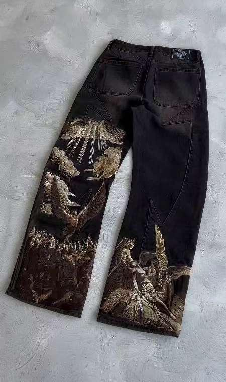 Celestial Force Black Jeans featuring intricate artwork on the legs for a unique style