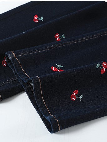 Close-up of Cherry Embroidered Wide Leg Jeans showcasing detailed embroidery on dark fabric