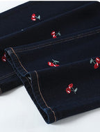 Close-up of Cherry Embroidered Wide Leg Jeans showcasing detailed embroidery on dark fabric
