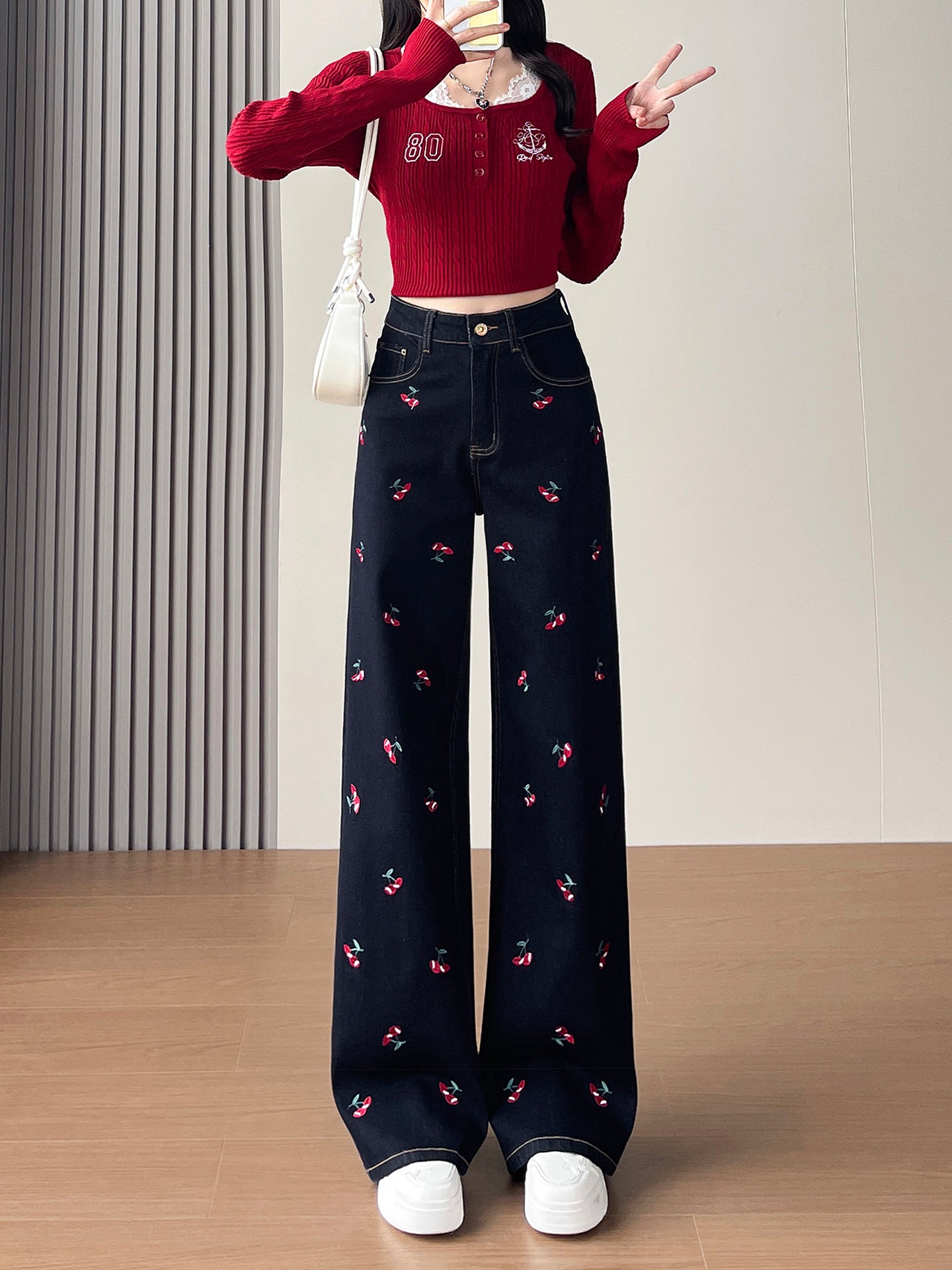 Cherry Embroidered Wide Leg Jeans featuring a high waist and cherry designs, styled with a red top