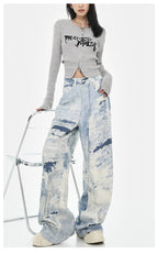 Model wearing Cloud Wash High Street Wide Leg Jeans with a stylish grey crop top
