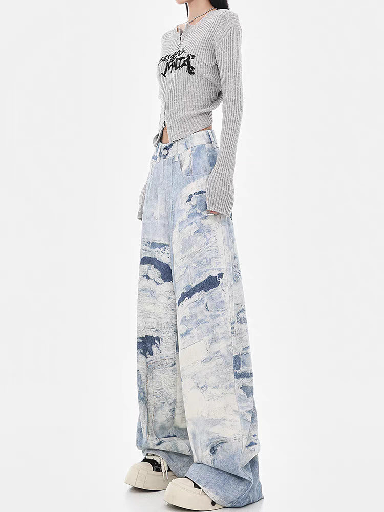 Model wearing Cloud Wash High Street Wide Leg Jeans with a stylish fitted gray top and chunky sneakers