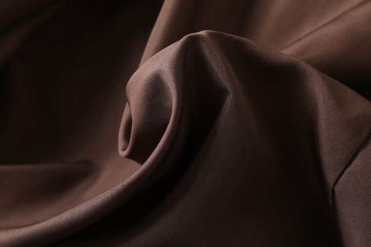 Close-up of rich brown fabric showcasing the texture of Colette 70s Goatskin Jacket