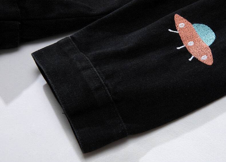 Close-up of AM Vision RO Denim Jacket with Embroidered Details featuring colorful UFO design on sleeve