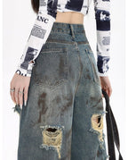 Back view of destroyed flared jeans with distressed details and a high waist design