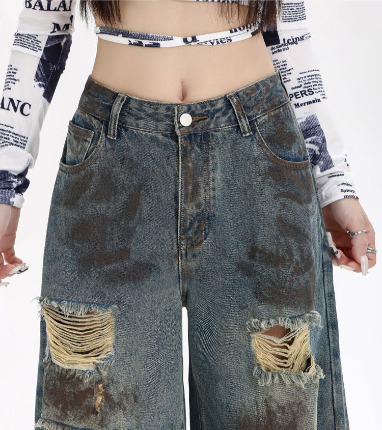 Destroyed Flared Jeans with Distressed Rips and a Vintage Wash for a Trendy Look