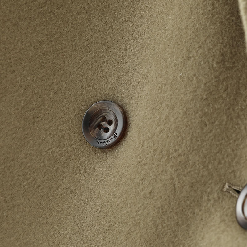 Close-up of a button on the Double-Faced Wool Velvet Coat by AM Vision RO in a warm, neutral tone