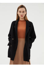 Stylish model wearing a Double-Faced Wool Velvet Coat over a brown sweater and pleated skirt