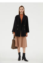 Stylish Double-Faced Wool Velvet Coat in black, layered over a tan dress with a tote bag