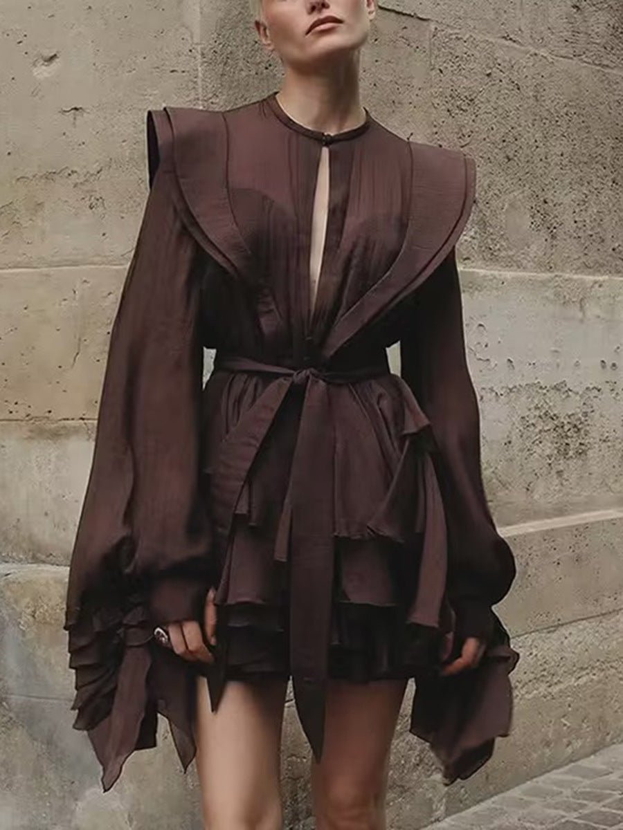 Stylish dress with asymmetric design and cut-out details featuring dramatic sleeves and a belted waist