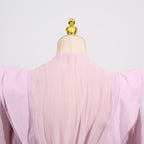 Back view of a pink dress with asymmetric design and cut-out details for a stylish look