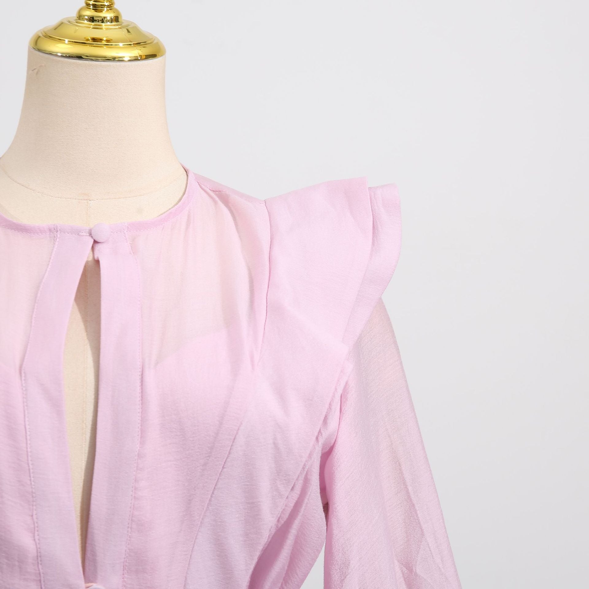 Pink Dress with Asymmetric Design and Cut-Out Details featuring delicate ruffle sleeves