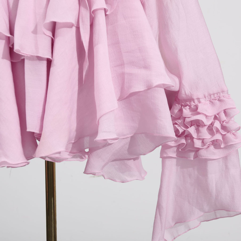 Pink Dress with Asymmetric Design and Cut-Out Details featuring ruffled sleeves and a flowing silhouette