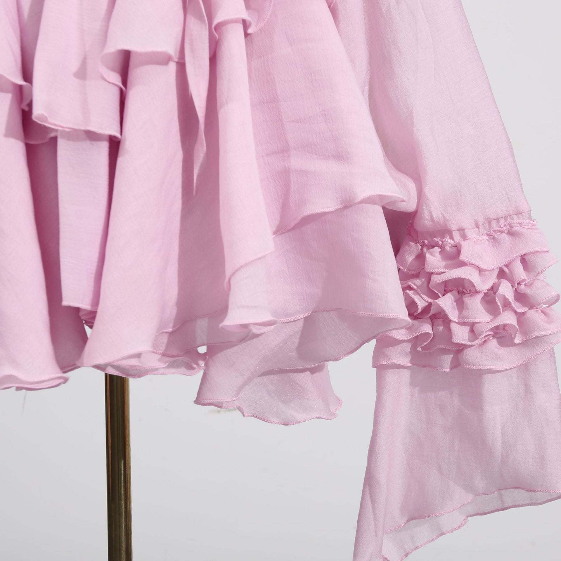 Pink Dress with Asymmetric Design and Cut-Out Details featuring ruffled sleeves and a flowing silhouette