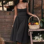Elegant black dress with minimalist design featuring a fitted bodice and flowy skirt