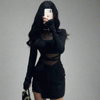 Stylish black dress with transparent inserts, featuring long sleeves and a chic silhouette