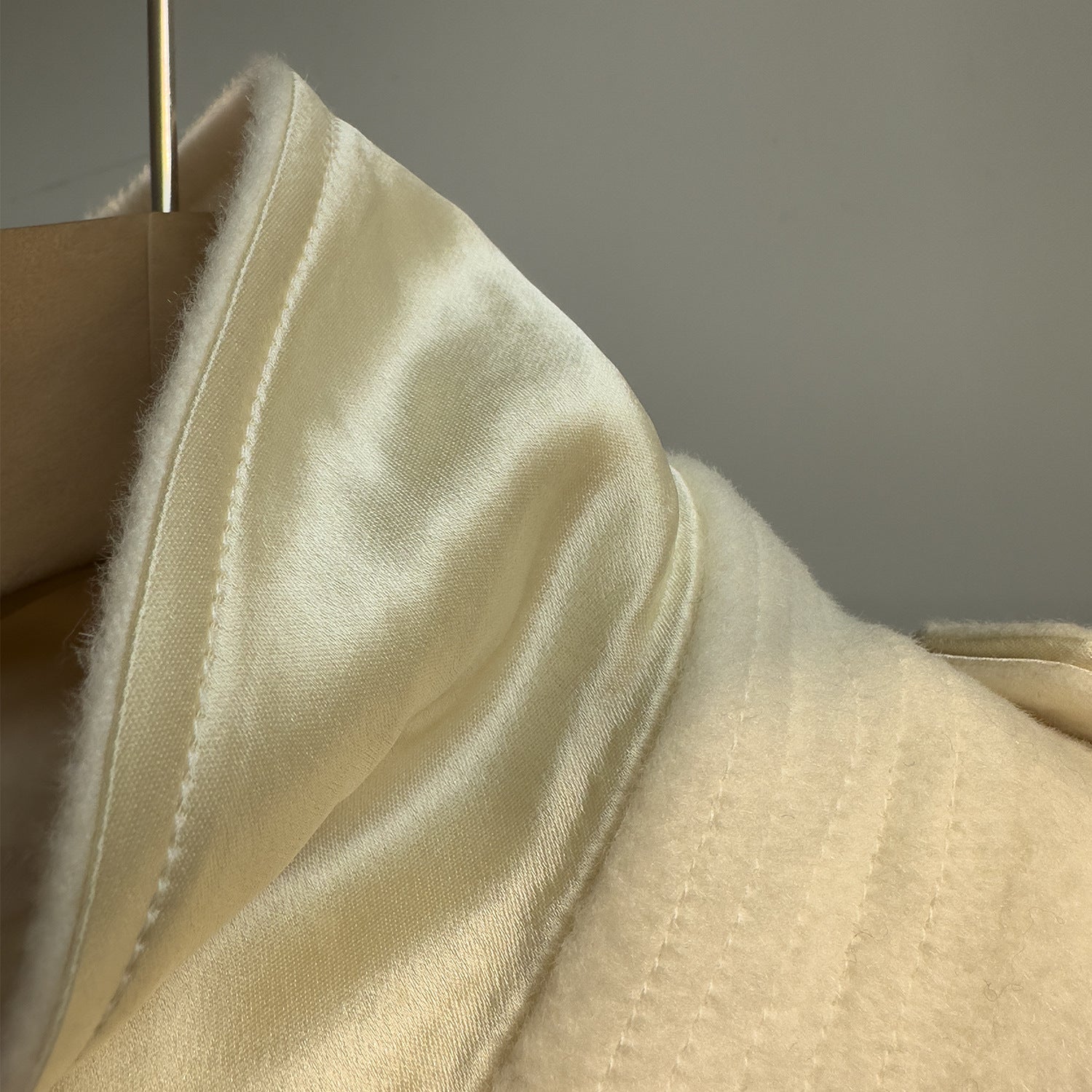 Close-up of Elara Wool Coat Cashmere X Mulberry Silk showing luxurious fabric and satin sheen