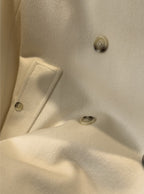 Close-up of the Elara Wool Coat Cashmere X Mulberry Silk featuring elegant buttons and soft fabric texture