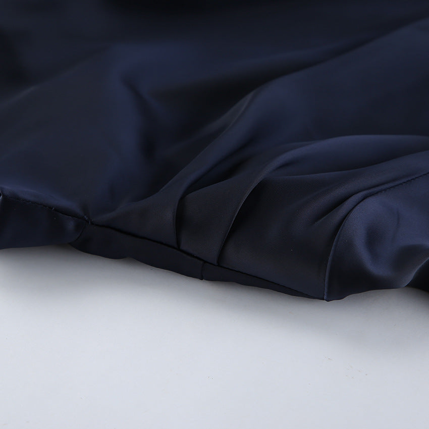 Close-up of silky fabric showcasing the Elegant Bell Sleeve Dress in deep navy color