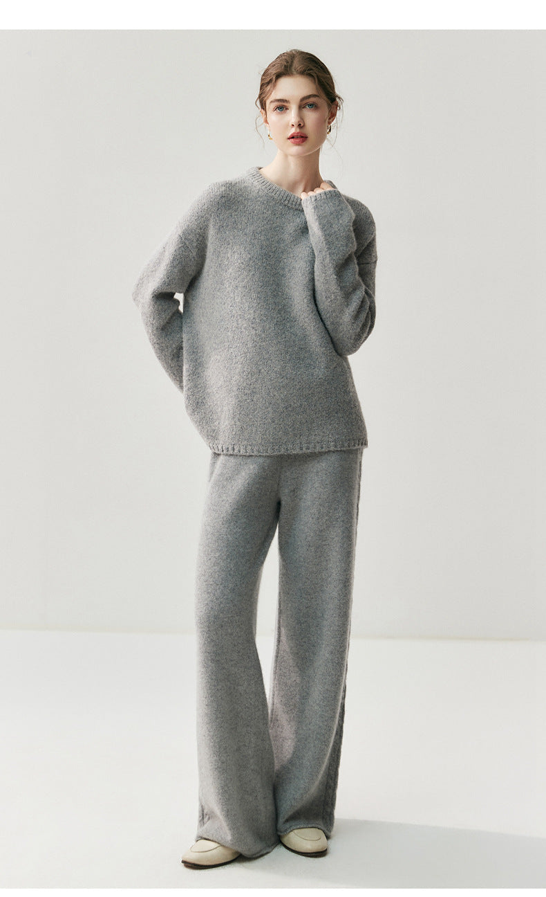Stylish model wearing elegant cashmere lounge pants paired with a matching sweater in gray