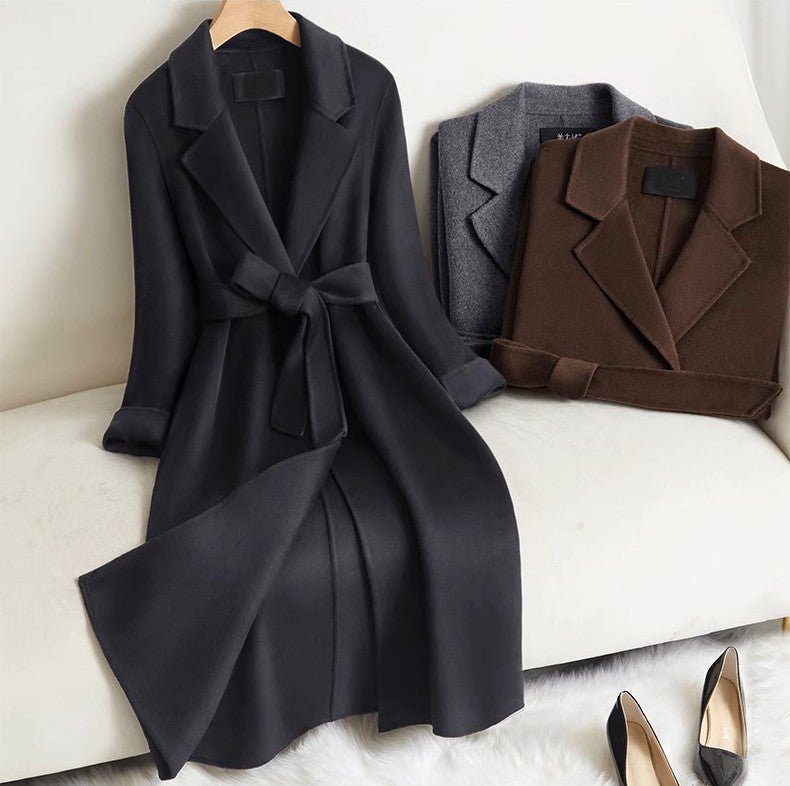 Elegant Wool And Cashmere Coat With Fitted Cut And Suit Collar in black and brown displayed on a cozy chair