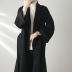 Eloane Elegant Ripple Wool Coat in black, featuring a minimalist design and flowing silhouette