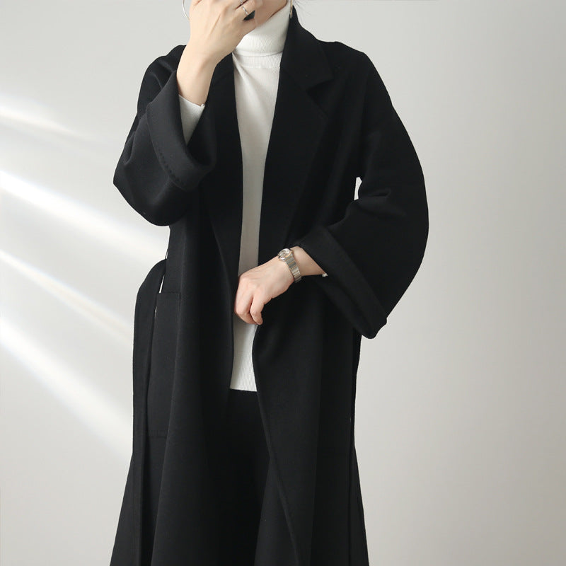 Eloane Elegant Ripple Wool Coat in black, featuring a minimalist design and flowing silhouette