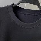Close-up of a black Embroidered Bear T-Shirt showcasing the round neckline and fabric texture